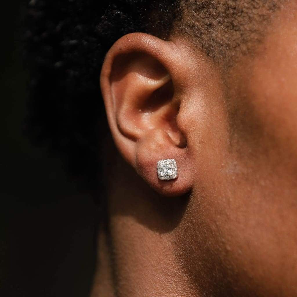 Close-up image of a person wearing white gold diamond stud earrings